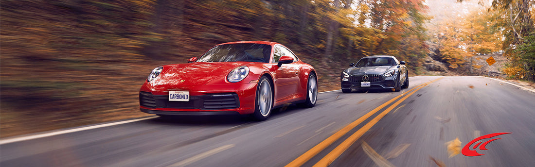 A high-end Porsche and a Mercedes speeding on a winding road.